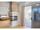 A luxurious main bedroom features a stone fireplace, hardwood floors, and sliding doors to a private balcony at 2041 Troon Dr, Henderson, NV 89074