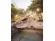 Unique rock waterfall feature adds tranquility and natural beauty to this home's outdoor space at 2041 Troon Dr, Henderson, NV 89074