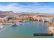 Picturesque aerial view of lakefront homes with docks, boats, and beautiful mountain views at 21 Via Visione # 201, Henderson, NV 89011