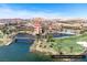Picturesque view of Reflection Bay Golf Course, lush greenery, and a bridge over the water feature at 21 Via Visione # 201, Henderson, NV 89011