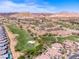 Aerial shot of homes overlooking a golf course, set against a backdrop of desert landscape at 21 Via Visione # 201, Henderson, NV 89011