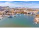 Aerial view of waterfront properties in a town setting near a serene lake with boat docks at 21 Via Visione # 201, Henderson, NV 89011