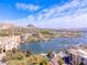 Picturesque aerial view of lakeside properties with mountain views, docks, and boats on the water at 21 Via Visione # 201, Henderson, NV 89011