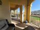 Inviting balcony space with elegant columns and stunning golf course and mountain views at 21 Via Visione # 201, Henderson, NV 89011