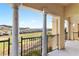 A beautiful balcony featuring sleek metal railings, elegant pillars, and stunning views of the surrounding landscape at 21 Via Visione # 201, Henderson, NV 89011