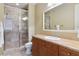 Bathroom featuring a glass enclosed shower, tile accents and vanity with storage at 21 Via Visione # 201, Henderson, NV 89011