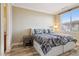 Bedroom with two twin beds featuring patterned bedding, bedside table, and natural light at 21 Via Visione # 201, Henderson, NV 89011