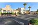 Clubhouse exterior with detailed architecture, desert landscaping, and parking at 21 Via Visione # 201, Henderson, NV 89011