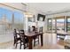 Inviting dining area with a modern light fixture, seamlessly connected to the outdoor balcony at 21 Via Visione # 201, Henderson, NV 89011