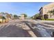 Community gated entrance with decorative stone columns and pavers offers security and curb appeal at 21 Via Visione # 201, Henderson, NV 89011