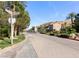 A street view leading to a stone guardhouse and a neighborhood at 21 Via Visione # 201, Henderson, NV 89011