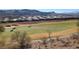 Scenic view of the golf course with mountain views and houses in the background on a sunny day at 21 Via Visione # 201, Henderson, NV 89011