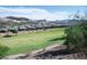 Scenic view of the green golf course and the neighboring homes against the desert mountains at 21 Via Visione # 201, Henderson, NV 89011