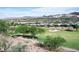 Scenic view of the green golf course with desert mountains in the background, surrounded by lush trees at 21 Via Visione # 201, Henderson, NV 89011