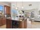 Gourmet kitchen featuring an oversized kitchen island and breakfast bar, tile backsplash, and stainless appliances at 21 Via Visione # 201, Henderson, NV 89011