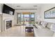 Comfortable living room with fireplace and sliding doors to a private balcony at 21 Via Visione # 201, Henderson, NV 89011