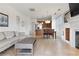 Bright, open-concept living room with tile floors, fireplace, and open kitchen layout at 21 Via Visione # 201, Henderson, NV 89011