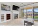 Inviting living room with fireplace, tile flooring and a wonderful view of the outdoors through a large sliding glass door at 21 Via Visione # 201, Henderson, NV 89011