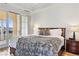 Bright main bedroom featuring balcony access and comfortable bedding at 21 Via Visione # 201, Henderson, NV 89011