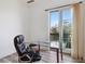 Bright office space featuring wood floors, a modern glass desk, and balcony access at 21 Via Visione # 201, Henderson, NV 89011
