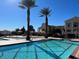 Community pool featuring plenty of space to enjoy the outdoors and palm trees with nearby seating and lounge areas at 21 Via Visione # 201, Henderson, NV 89011