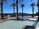 Community pools surrounded by lush greenery, palm trees and cabanas, offering a private escape for residents at 21 Via Visione # 201, Henderson, NV 89011