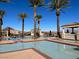Multiple community pools offer relaxation, with cabanas and palm trees enhance the resort-style experience at 21 Via Visione # 201, Henderson, NV 89011