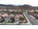 Aerial view of a residential neighborhood surrounded by a mountain range, showcasing desert landscaping at 2125 Desert Woods Dr, Henderson, NV 89012