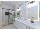 Modern bathroom featuring double sink vanity, and walk-in shower with black trim at 2125 Desert Woods Dr, Henderson, NV 89012