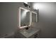 Bright bathroom features a white sink and lighted mirror at 2125 Desert Woods Dr, Henderson, NV 89012