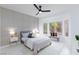 Bright bedroom with decorative wall, ceiling fan, and bay window seating area at 2125 Desert Woods Dr, Henderson, NV 89012