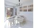 Elegant dining area featuring modern chandelier and views of the outdoor landscape at 2125 Desert Woods Dr, Henderson, NV 89012