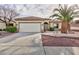 Charming single-story home with well-maintained landscaping and a spacious driveway at 2125 Desert Woods Dr, Henderson, NV 89012