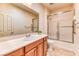 Bathroom includes a tub with sliding glass doors and shower, tile flooring, and single sink vanity at 2253 Laurel Heights Ln, Henderson, NV 89052