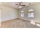 Comfortable bedroom with carpet flooring, ceiling fan, and arched windows providing ample natural light at 2253 Laurel Heights Ln, Henderson, NV 89052