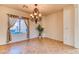 Inviting dining room with chandelier, tile flooring, and large window providing ample natural light at 2253 Laurel Heights Ln, Henderson, NV 89052