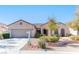Delightful single-story home with a two-car garage, xeriscaped front yard and a charming stone garden wall at 2253 Laurel Heights Ln, Henderson, NV 89052