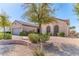 Lovely home featuring desert landscaping, two arched windows, and a brick-lined garden at 2253 Laurel Heights Ln, Henderson, NV 89052