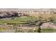 Picturesque golf course view with desert landscape, featuring golfers and carts at 2253 Laurel Heights Ln, Henderson, NV 89052