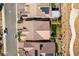 Aerial view of a home's roof with solar panels and a landscaped backyard with a cozy outdoor seating area at 24 Cliffwater St, Henderson, NV 89011