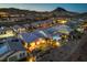 Night aerial view of a residential neighborhood with mountain views; featuring manicured lawns and inviting outdoor spaces at 24 Cliffwater St, Henderson, NV 89011