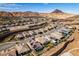 Expansive aerial view of the desert community, showcasing homes, landscaping, and mountain views at 24 Cliffwater St, Henderson, NV 89011