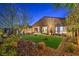 Beautiful backyard featuring a well-manicured lawn and an inviting outdoor seating area with a fire pit at 24 Cliffwater St, Henderson, NV 89011