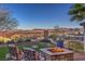 Backyard lounge area with fire pit and mountain views at 24 Cliffwater St, Henderson, NV 89011