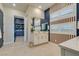 Spacious bathroom featuring a double vanity, wooden accent wall and an adjoining walk-in closet at 24 Cliffwater St, Henderson, NV 89011