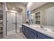 Bright bathroom with a glass enclosed shower, double sink vanity, and neutral color palette at 24 Cliffwater St, Henderson, NV 89011