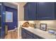 Hallway with blue cabinets, light countertops, a powder room and an area for a laptop or tablet at 24 Cliffwater St, Henderson, NV 89011