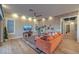 Bright living room with a flat screen television, hardwood floors, and a view into the entrance hall at 24 Cliffwater St, Henderson, NV 89011