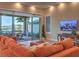 Cozy living room with a large sofa, sliding glass doors to the outside, and hardwood floors at 24 Cliffwater St, Henderson, NV 89011