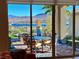 Inviting patio with outdoor seating and stunning lake view visible through sliding glass doors at 24 Cliffwater St, Henderson, NV 89011